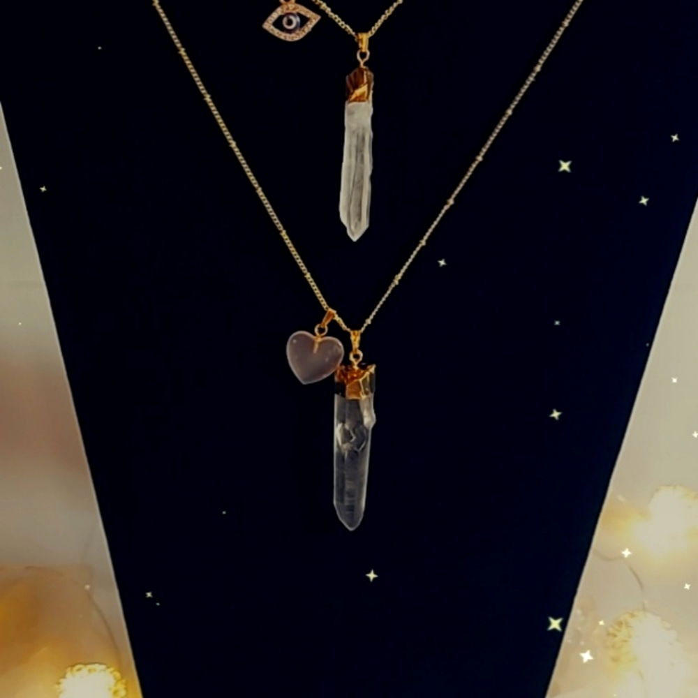 Clear quartz and a rose quartz charms On a gold tone necklace